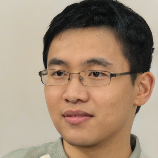 Joyful asian young-adult male with short  black hair and brown eyes