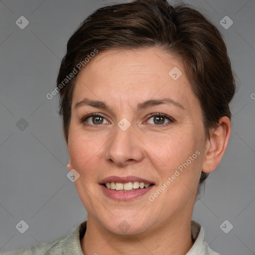 Joyful white adult female with short  brown hair and grey eyes