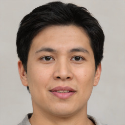 Joyful asian young-adult male with short  brown hair and brown eyes