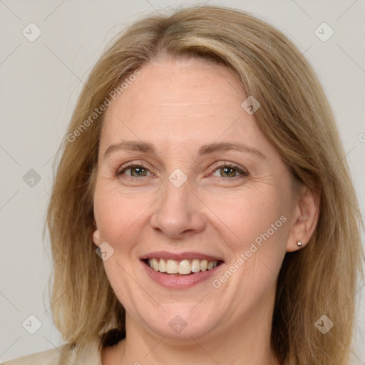 Joyful white adult female with medium  brown hair and green eyes