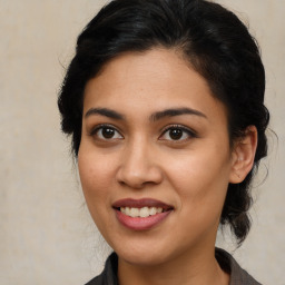 Joyful latino young-adult female with medium  brown hair and brown eyes