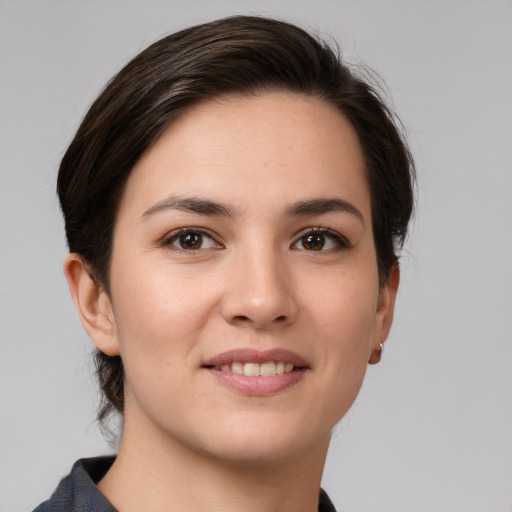 Joyful white young-adult female with medium  brown hair and brown eyes