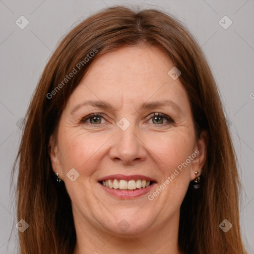 Joyful white adult female with long  brown hair and grey eyes