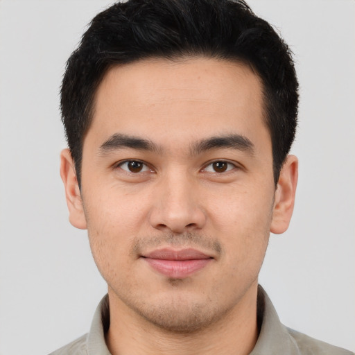 Joyful latino young-adult male with short  brown hair and brown eyes