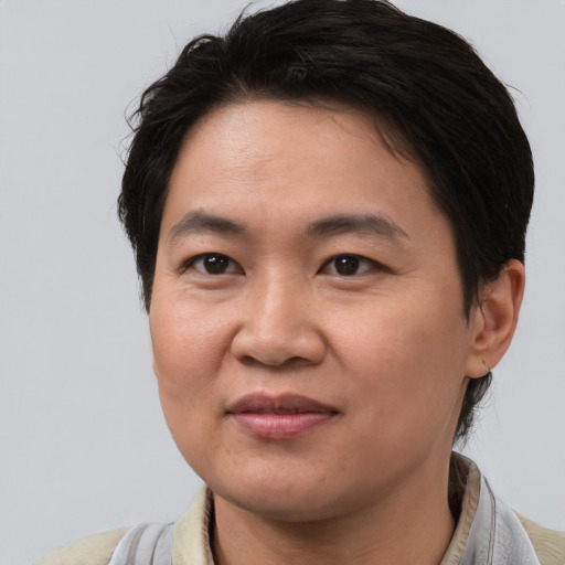 Joyful asian young-adult female with short  brown hair and brown eyes