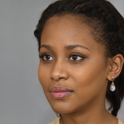 Neutral black young-adult female with long  brown hair and brown eyes