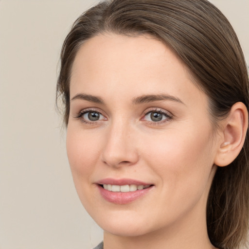 Joyful white young-adult female with long  brown hair and grey eyes