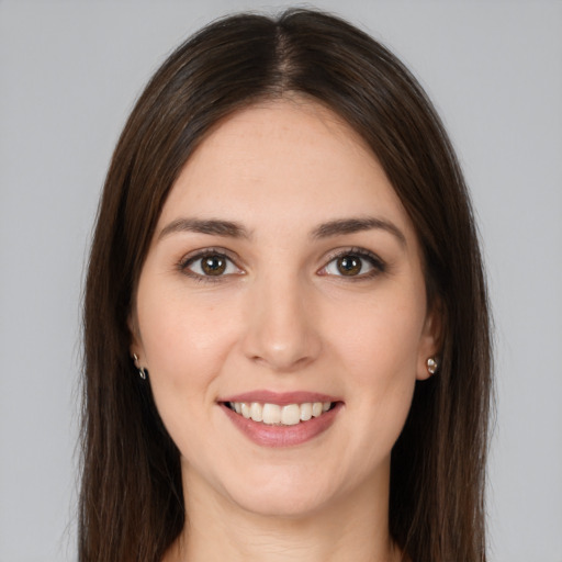 Joyful white young-adult female with long  brown hair and brown eyes