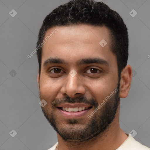 Joyful black young-adult male with short  black hair and brown eyes