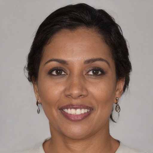 Joyful black young-adult female with medium  brown hair and brown eyes