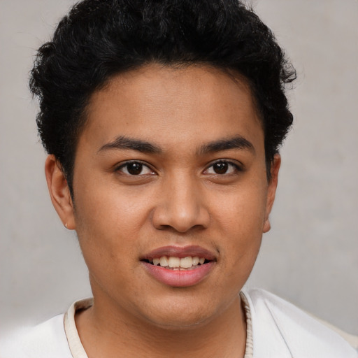 Joyful latino young-adult male with short  brown hair and brown eyes