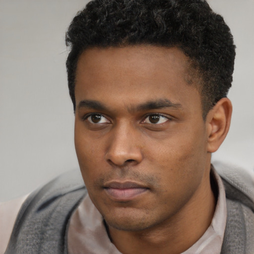 Neutral black young-adult male with short  black hair and brown eyes