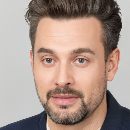 Joyful white adult male with short  brown hair and brown eyes