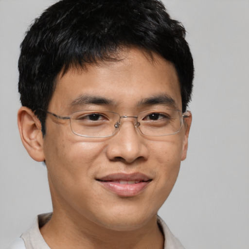 Joyful asian young-adult male with short  brown hair and brown eyes
