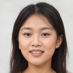 Joyful asian young-adult female with long  brown hair and brown eyes