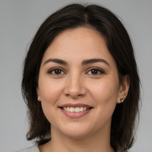 Joyful white young-adult female with medium  brown hair and brown eyes
