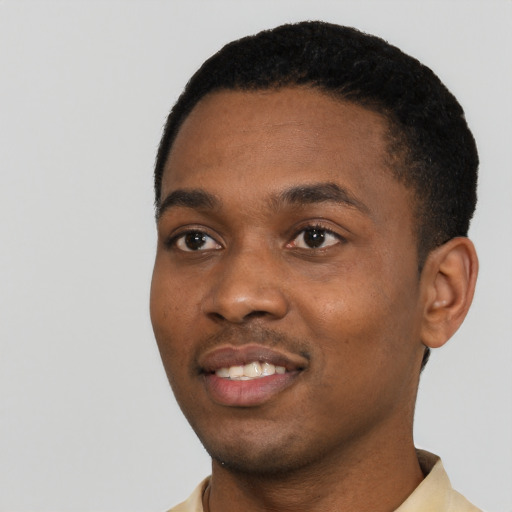 Joyful black young-adult male with short  black hair and brown eyes