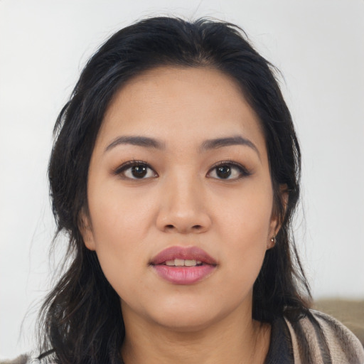 Joyful asian young-adult female with long  black hair and brown eyes
