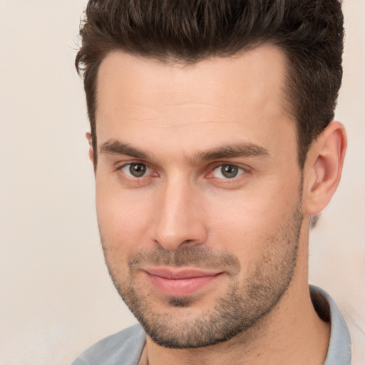 Joyful white young-adult male with short  brown hair and brown eyes