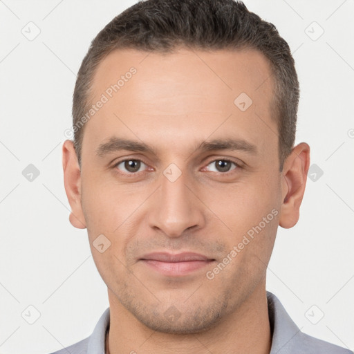 Joyful white young-adult male with short  brown hair and brown eyes