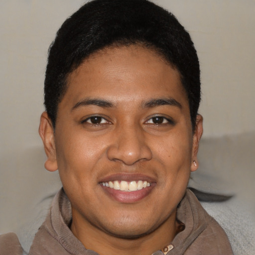 Joyful black young-adult female with short  brown hair and brown eyes