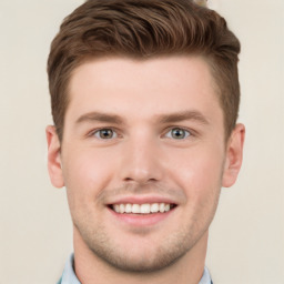 Joyful white young-adult male with short  brown hair and grey eyes