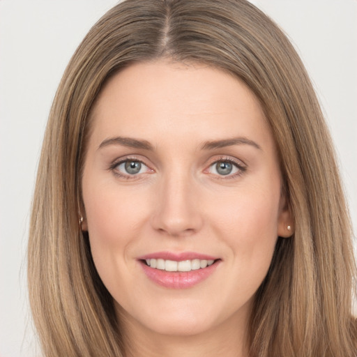 Joyful white young-adult female with long  brown hair and brown eyes