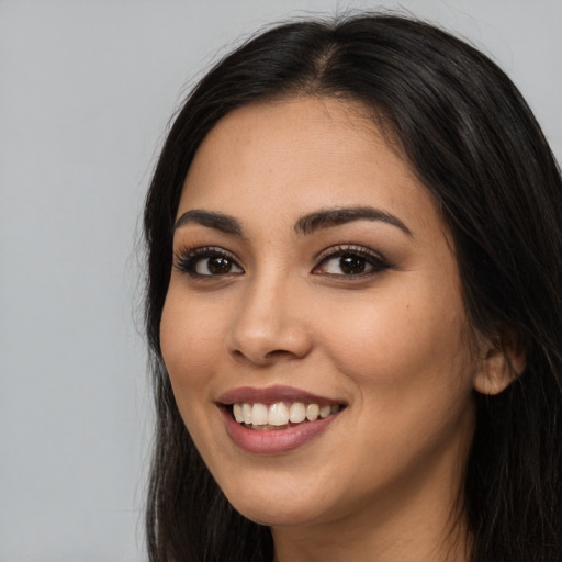 Joyful white young-adult female with long  black hair and brown eyes