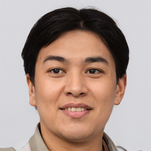 Joyful asian young-adult male with short  brown hair and brown eyes
