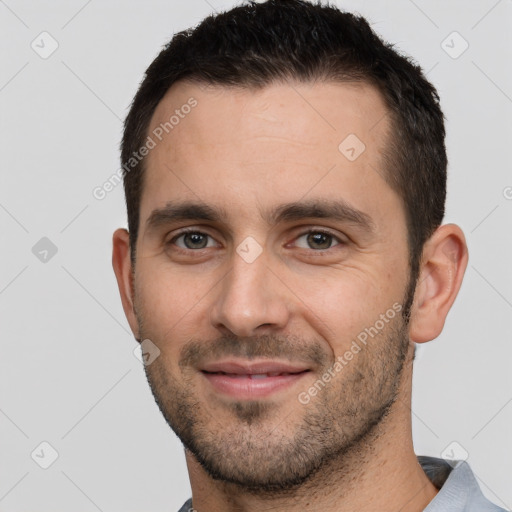 Joyful white young-adult male with short  brown hair and brown eyes