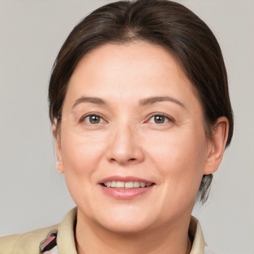 Joyful white adult female with medium  brown hair and brown eyes