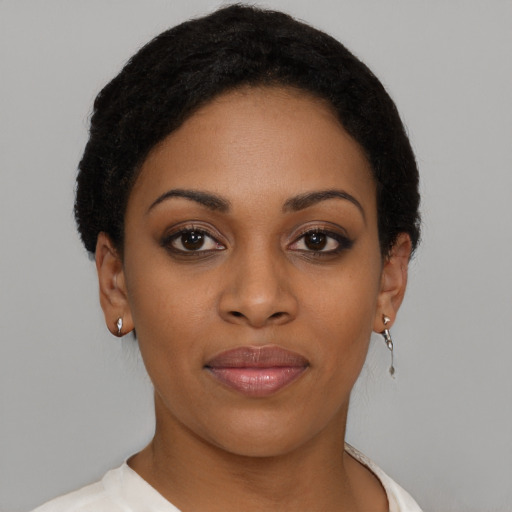 Joyful black young-adult female with short  brown hair and brown eyes