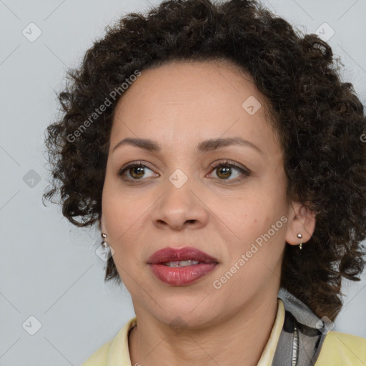 Joyful black adult female with medium  brown hair and brown eyes