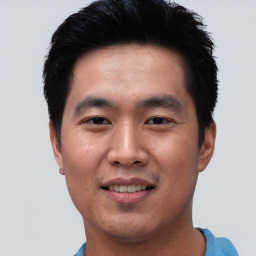 Joyful asian young-adult male with short  black hair and brown eyes