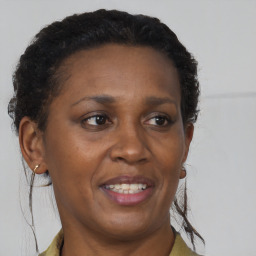 Joyful black adult female with short  brown hair and brown eyes