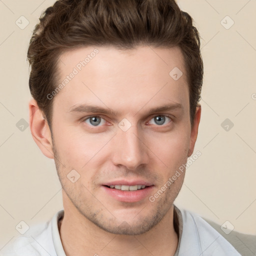 Joyful white young-adult male with short  brown hair and grey eyes