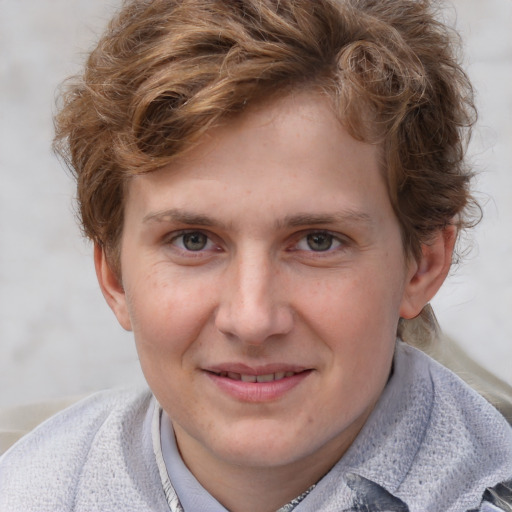 Joyful white young-adult male with short  brown hair and blue eyes