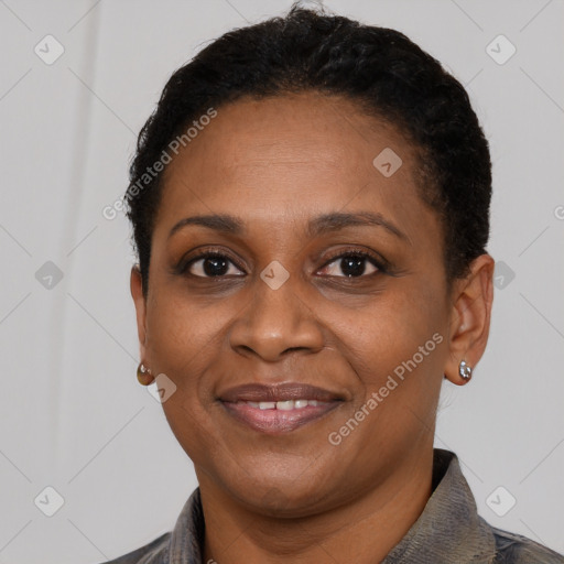 Joyful black adult female with short  brown hair and brown eyes