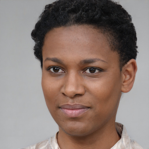 Joyful black young-adult female with short  black hair and brown eyes