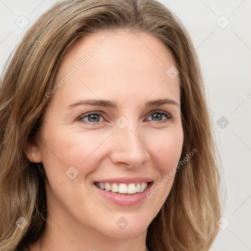 Joyful white young-adult female with long  brown hair and blue eyes