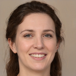 Joyful white young-adult female with medium  brown hair and brown eyes