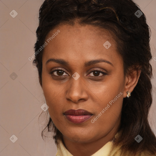 Joyful black young-adult female with long  brown hair and brown eyes