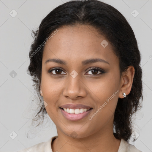 Joyful black young-adult female with medium  brown hair and brown eyes