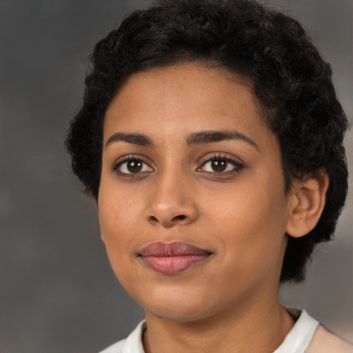 Joyful latino young-adult female with short  black hair and brown eyes