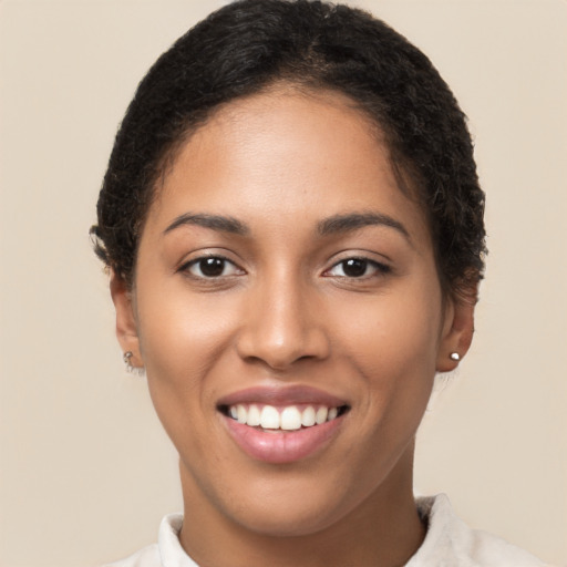 Joyful latino young-adult female with short  brown hair and brown eyes