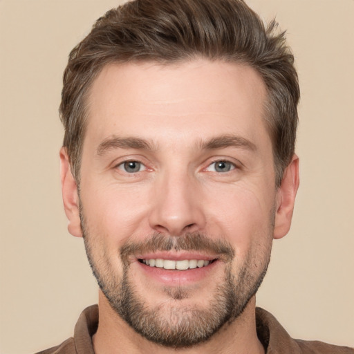 Joyful white adult male with short  brown hair and grey eyes