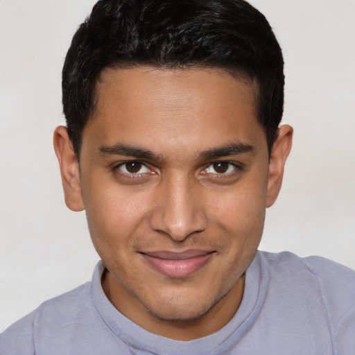 Joyful latino young-adult male with short  brown hair and brown eyes