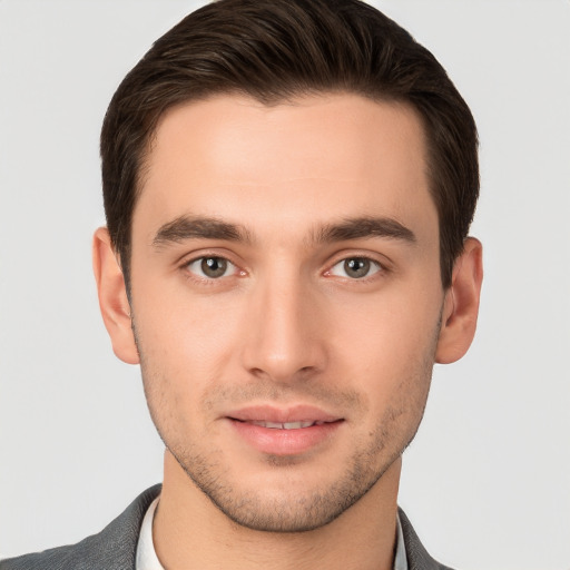 Joyful white young-adult male with short  brown hair and brown eyes