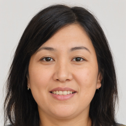 Joyful white adult female with long  brown hair and brown eyes