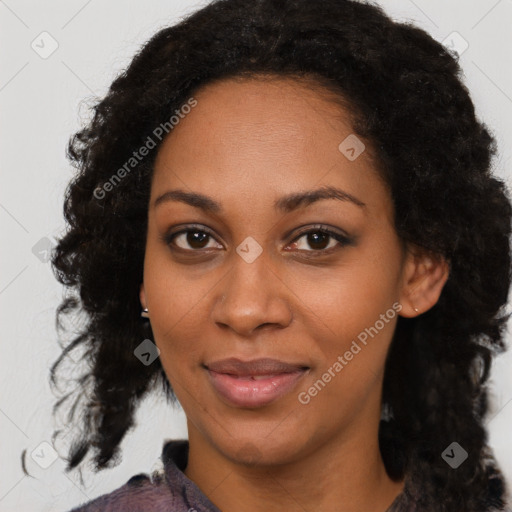 Joyful black young-adult female with long  black hair and brown eyes